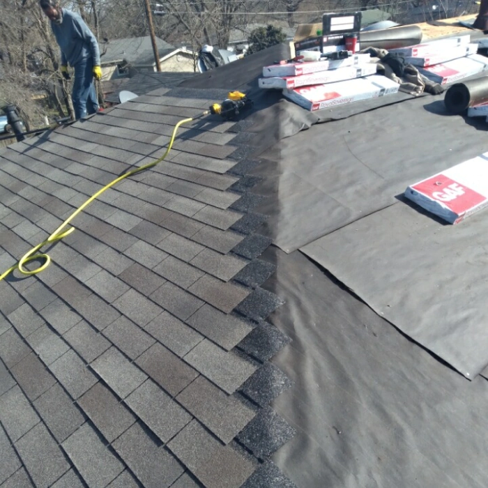 contractor installing shingle roof